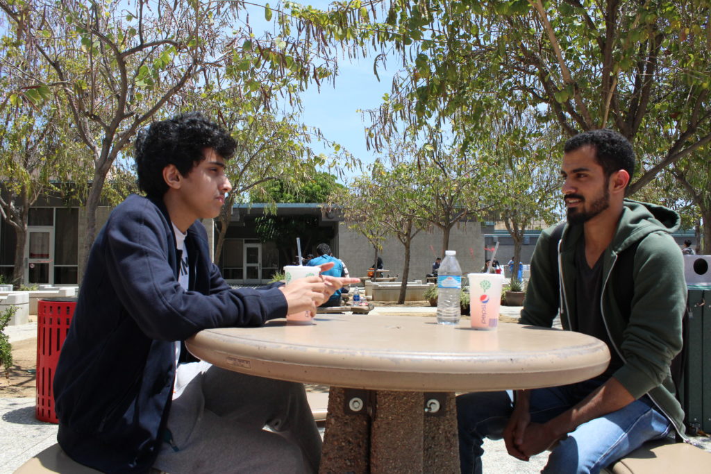 Faisal Aghammas (left), a 20-year-old business major at CSUN and Mashal AlShammari, a 25 year-old medical laboratory sciences major take a break before classes outside of CSUN's International and Exchange Students Center. Photo: Julius Lasin / El Nuevo Sol.